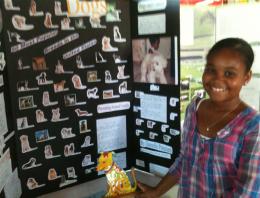 Danielle Petersen shows off her project about cancer in dogs, which won first place at the Animal Care Expo.